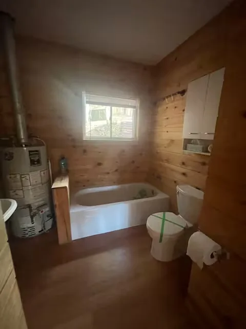 Bathroom with soaker tub and wood walls
