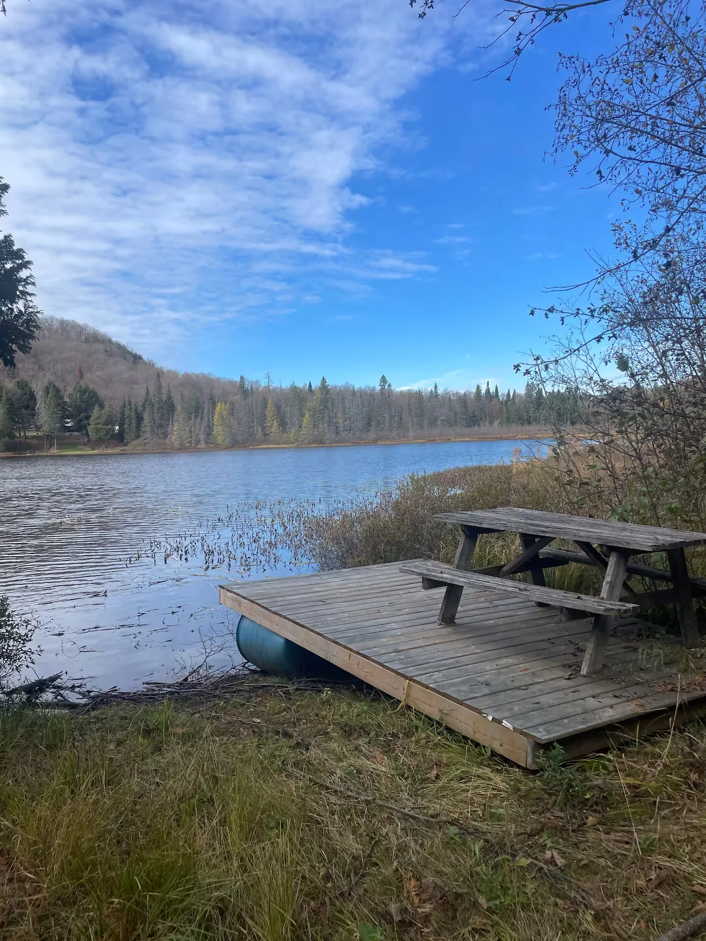 Wooden dock on Little McGarry Lake with canoe and picnic table