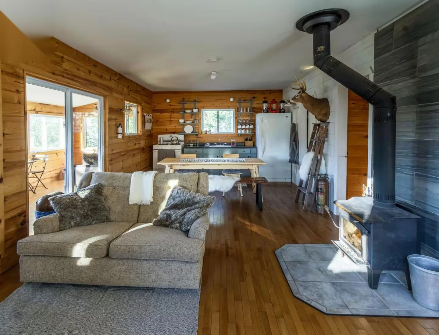 Open-plan living room with wood-burning fireplace and kitchen