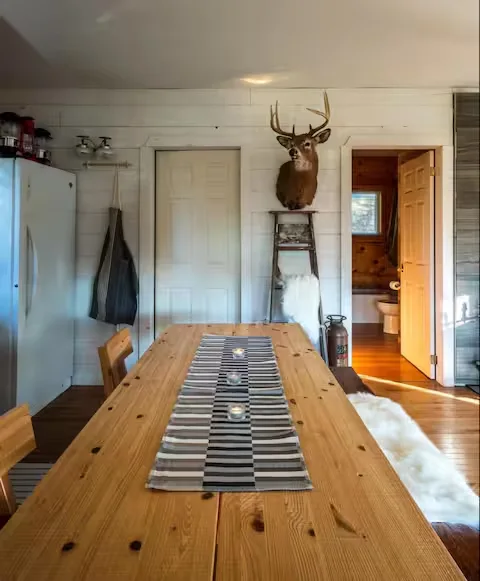 Dining room with pine table and deer mount